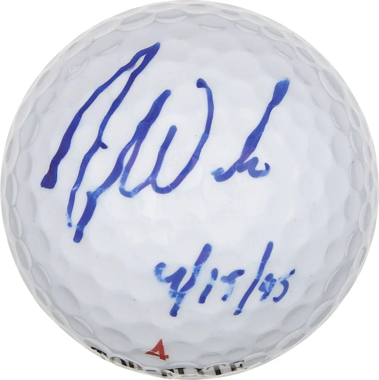 White golf ball with blue ink autograph and date written on it, sports memorabilia