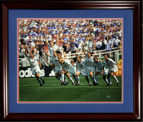 Framed photo of women's soccer team celebrating on field, signed by multiple players
