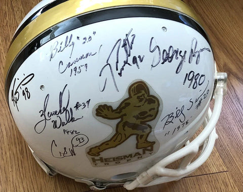 Heisman Trophy white football helmet with multiple signatures and gold logo