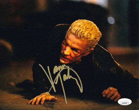 Signed 8x10 photo of a blonde man in dark clothing crawling on the ground from a TV scene