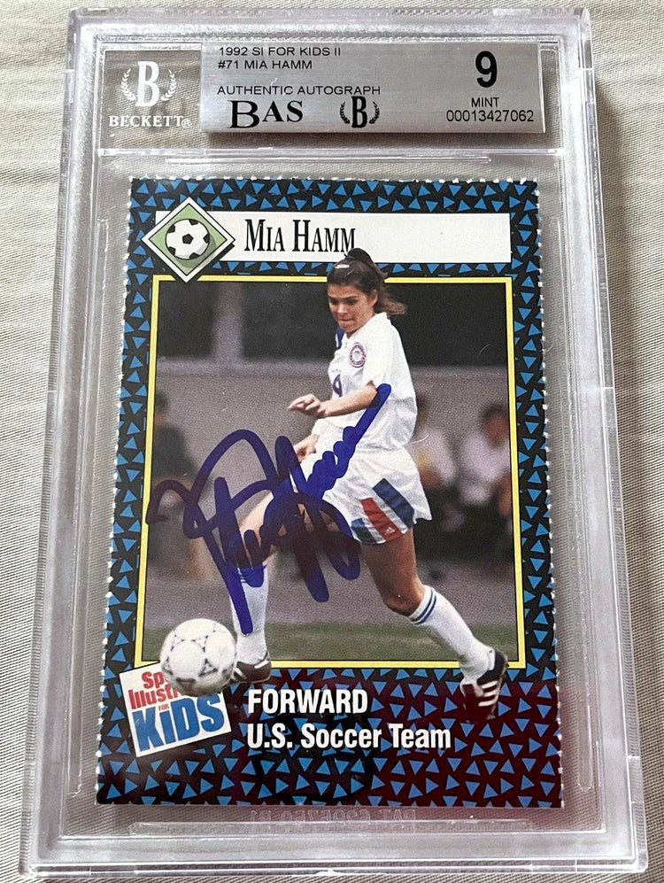 1992 Sports Illustrated for Kids soccer trading card, authenticated autograph, featuring player in white uniform kicking ball.