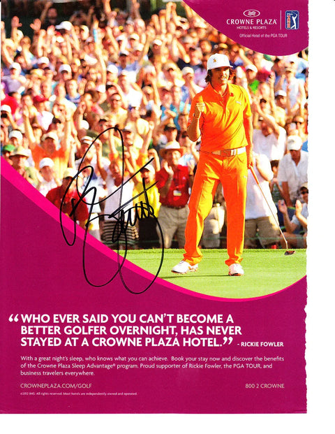 Golfer in orange outfit celebrating on course, crowd cheering, autograph over Crowne Plaza ad.