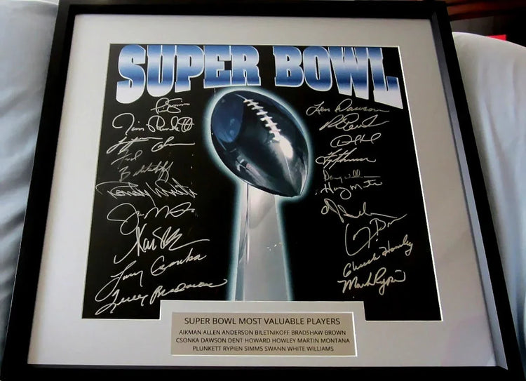Framed Super Bowl MVP football memorabilia with multiple autographs and trophy image.