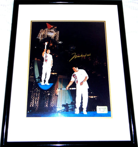 Framed 1996 Olympic torch relay photo with athlete in white uniform and autograph