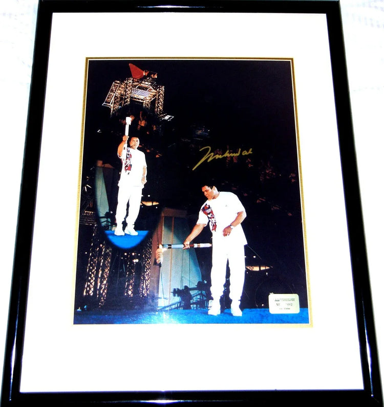 Framed 1996 Olympic torch relay photo with athlete in white uniform and autograph