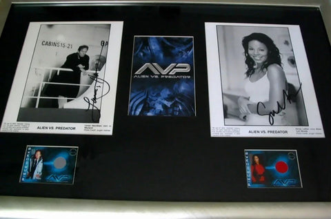 Framed Alien vs Predator memorabilia with signed cast photos and trading cards.