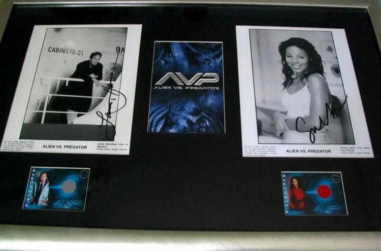 Framed Alien vs Predator memorabilia with signed cast photos and trading cards.