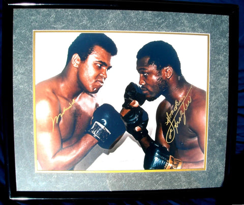 Framed boxing memorabilia photo with two boxers in gloves, featuring gold signatures.