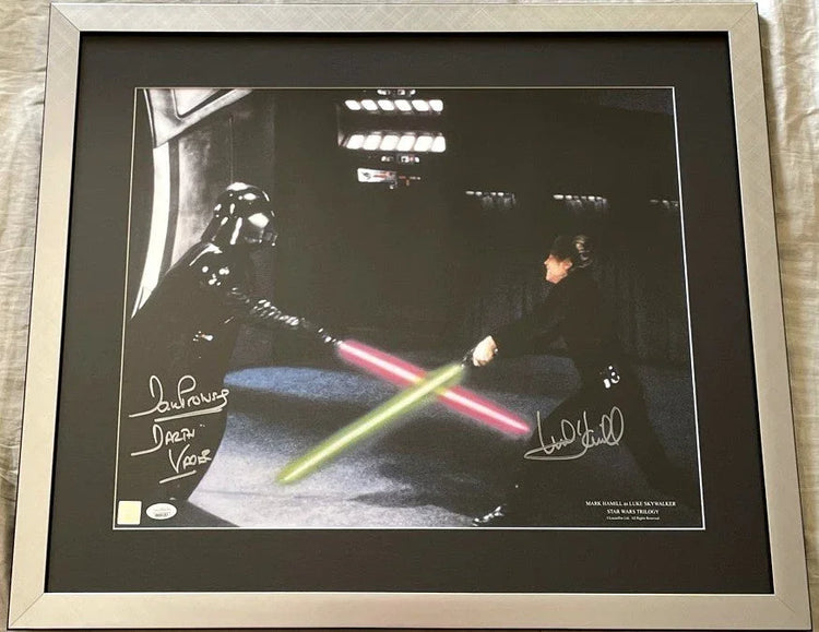 Framed autographed Star Wars photo with lightsaber duel between Darth Vader and Luke Skywalker.