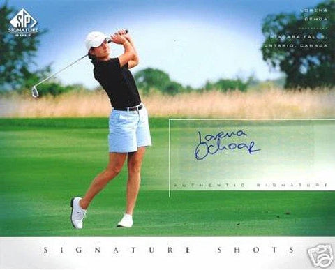 Female golfer in mid-swing on golf course, autographed memorabilia card