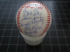 Official baseball with multiple MLB player autographs, displayed on a grid background