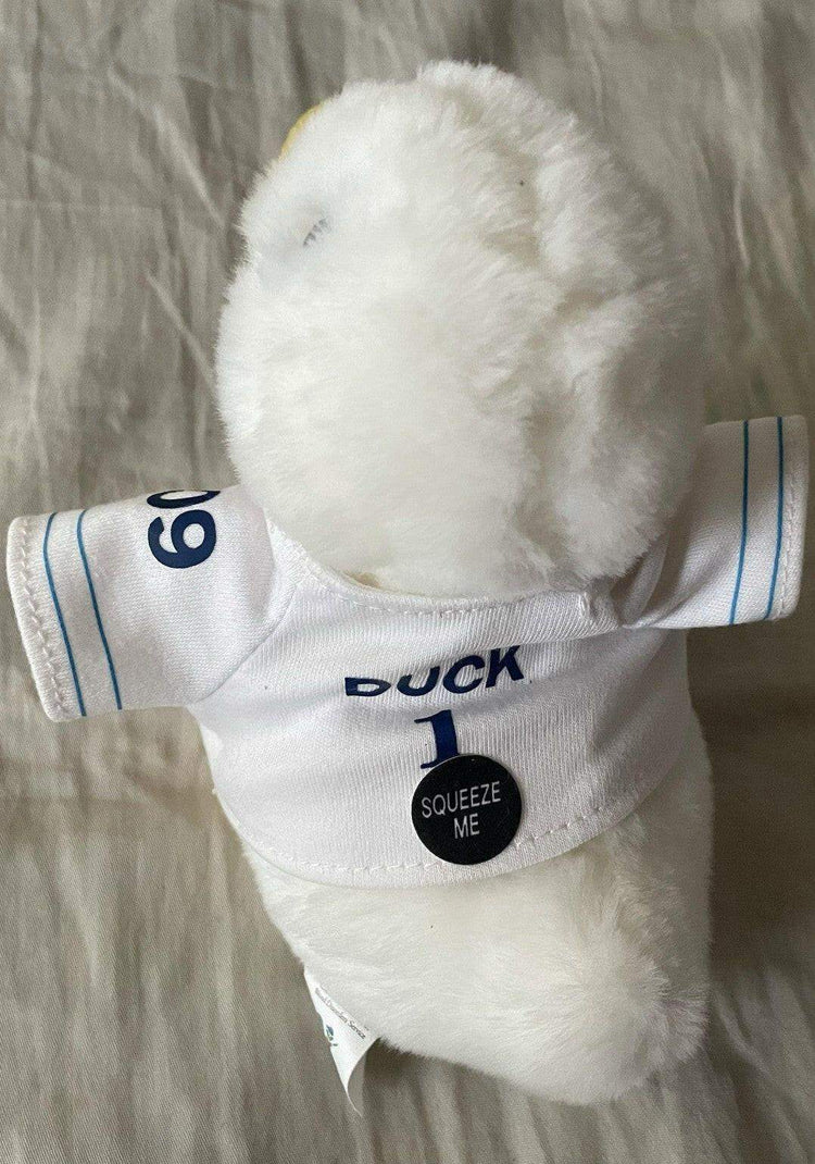 White plush duck in a sports jersey with 'Duck 1' and 'Squeeze Me' button, memorabilia item