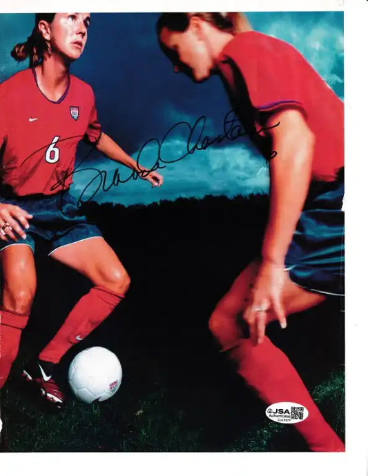 Autographed soccer photo of Mia Hamm in USA jersey, signed with JSA authentication, featuring action pose with ball.
