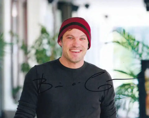 Autographed photo of actor Brian Geraghty smiling in red beanie, authentic signed memorabilia
