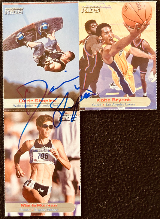 Three Sports Illustrated Kids trading cards featuring Darin Shapiro, Kobe Bryant, and Marla Runyan, with visible signatures.