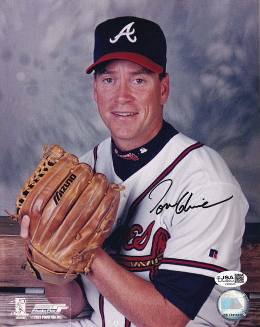 Atlanta Braves pitcher posing in uniform with signed baseball glove, autograph visible