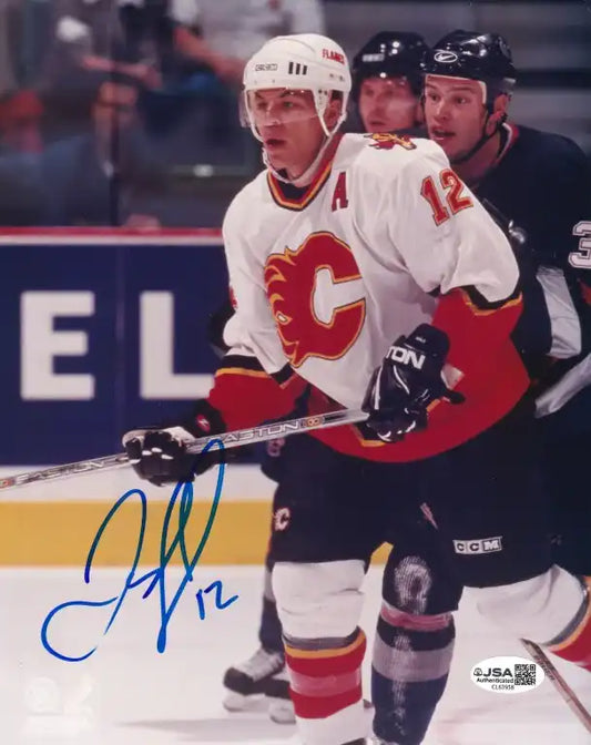 Autographed photo of Calgary Flames hockey player in action, signed with blue ink, JSA authenticated