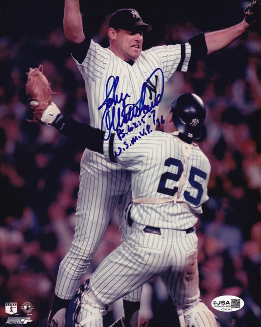 Baseball players in Yankees uniforms celebrating with autograph on photo, game action, JSA authenticated.