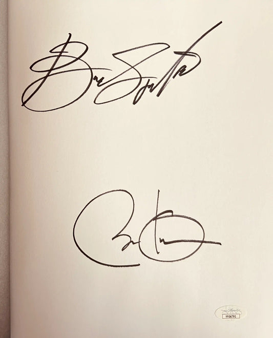 Signed book page with two large autographs and an authentication sticker, memorabilia
