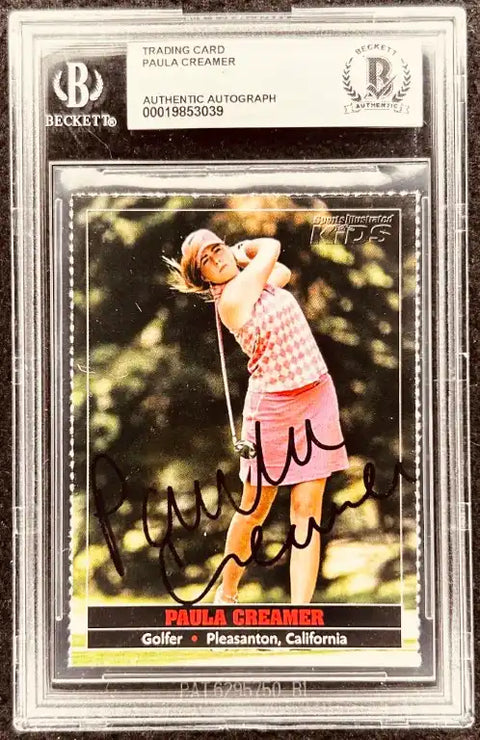 Paula Creamer autographed golf trading card, authenticated by Beckett, featuring her swing in pink attire.