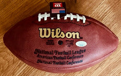 Official Wilson NFL football with laces and certification sticker on wood floor