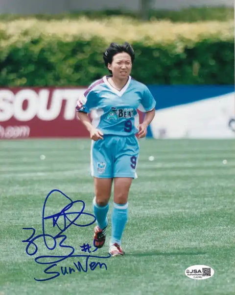 Autographed photo of Sun Wen in blue soccer jersey #9, JSA authenticated, on field during match