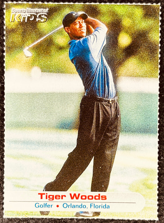 Tiger Woods Sports Illustrated Kids golf card showing Tiger Woods swinging a golf club outdoors.