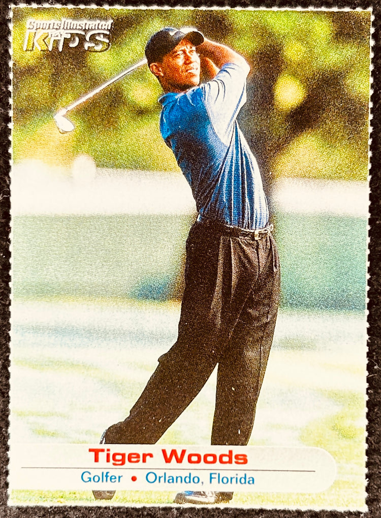 Tiger Woods Sports Illustrated Kids golf card showing Tiger Woods swinging a golf club outdoors.