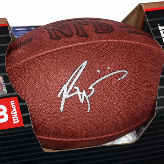 Autographed NFL football with silver signature, Wilson brand, displayed in packaging
