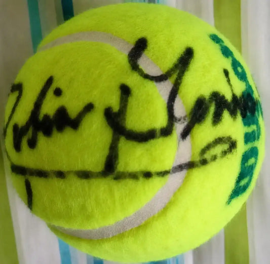 Autographed tennis ball with black marker signature, authentic sports memorabilia for collectors